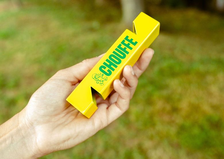 hand holding yellow Chouffe bottle opener